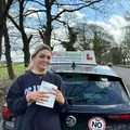 Tia Lees holding her practical driving test pass certificate